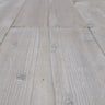 Close-up of rustic reclaimed wood planks with a natural greyish grain finish